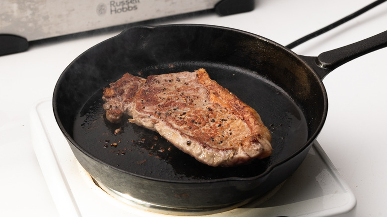 steak cooking in a pan