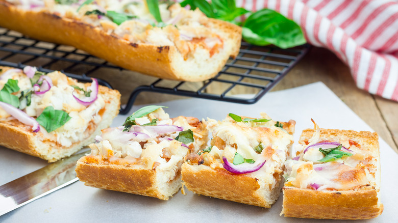 Sliced French bread pizza on parchment paper 