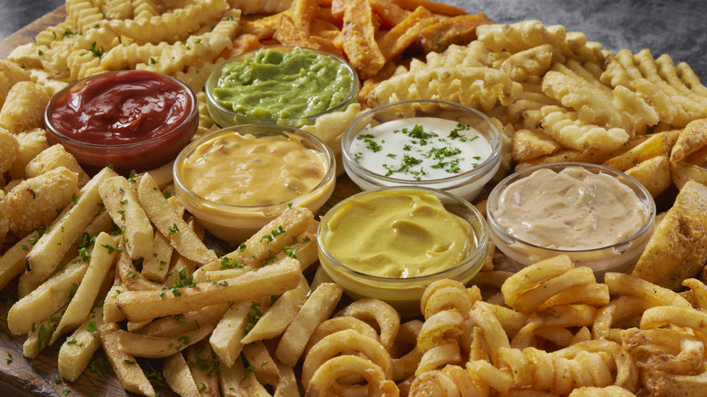 loaded french fries board with dipping sauces