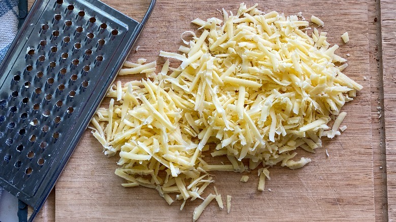 shredded cheese on cutting board