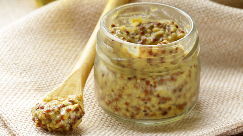 spoon and jar of Dijon mustard