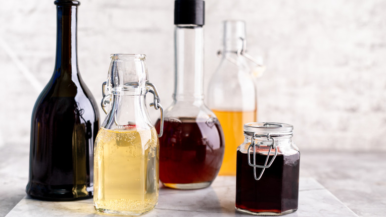 multiple glass bottles of vinegar