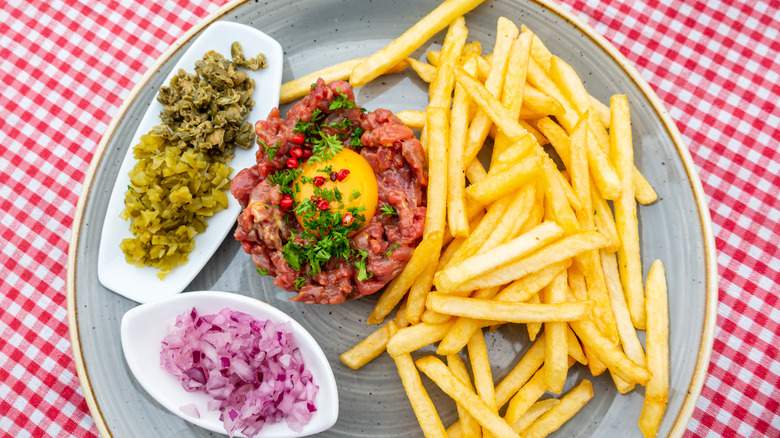 steak tartare with fries and pickles