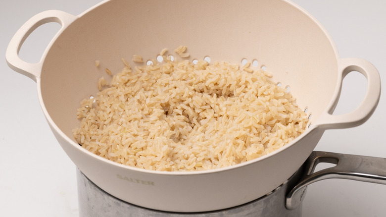 cooked rice in a colander