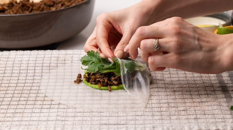 Rolling Thai basil beef rolls