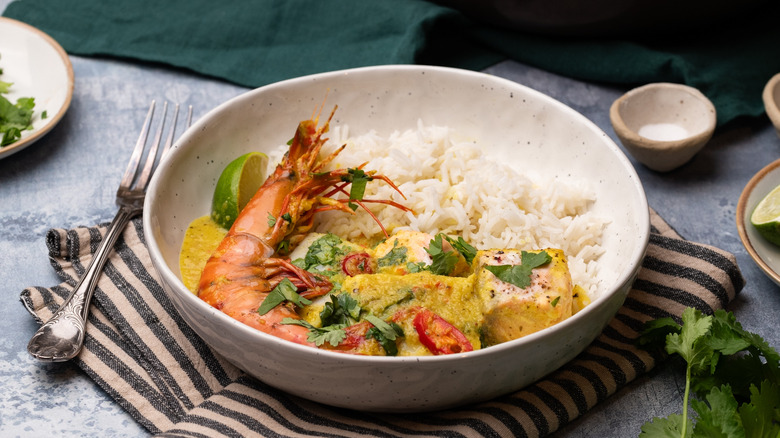 coconut fish curry over rice with prawn