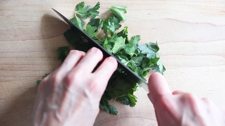 chopping fresh cilantro with knife