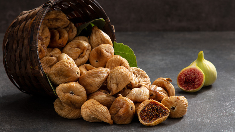 whole dried figs spilling out of a basket