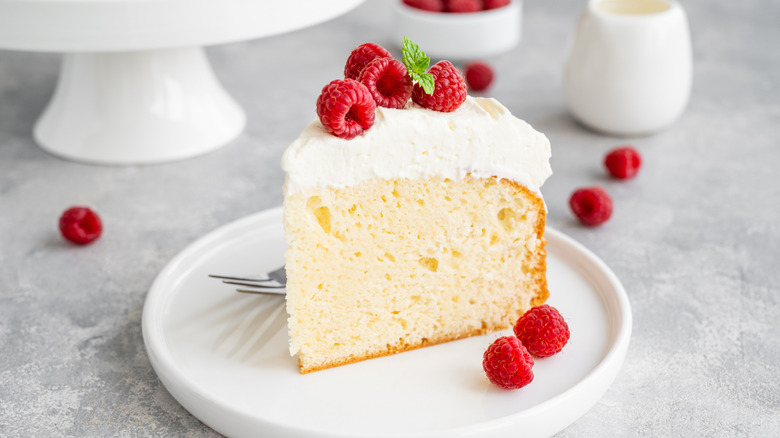 slice of tres leches cake with raspberries