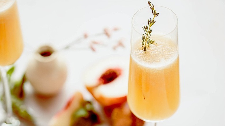 peach bellini with thyme sprig