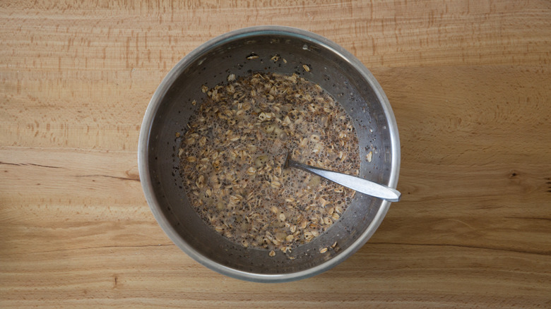 overnight oat mixture in metal bowl with fork