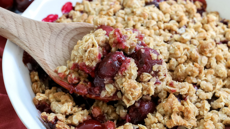 cherry crisp being scooped with a spoon