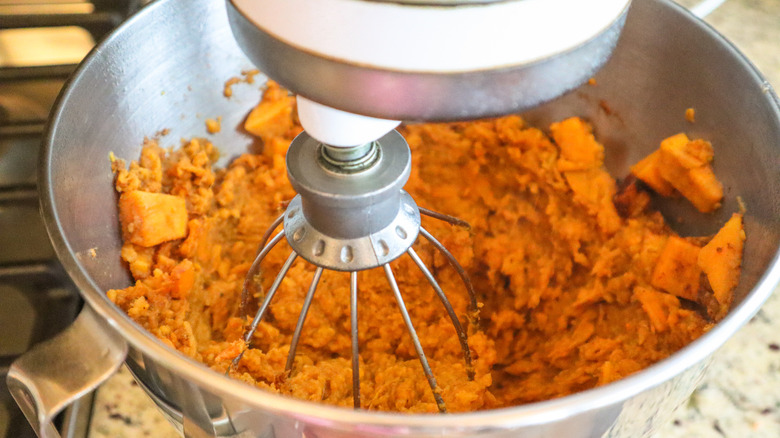 Mixing cooked sweet potato