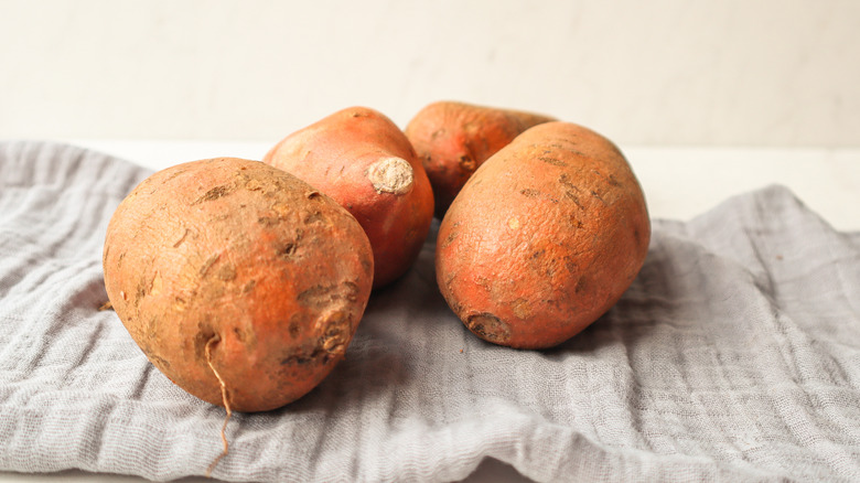 Several yams on a tea towel