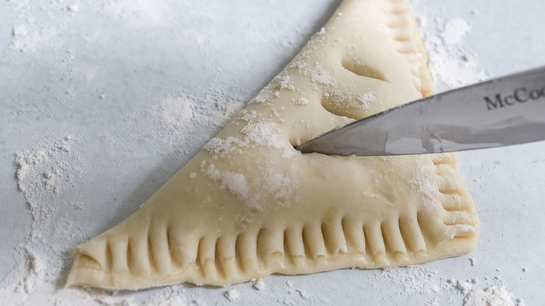 knife cutting slit into turnover