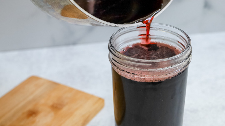 cherry juice pouring into jar