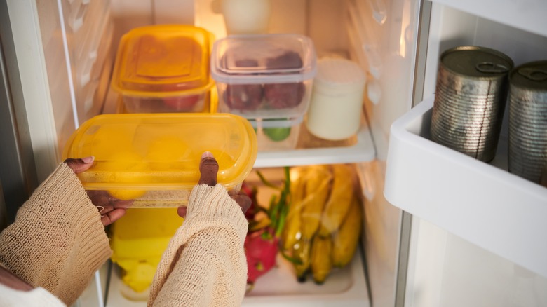 Foodie taking food container from fridge