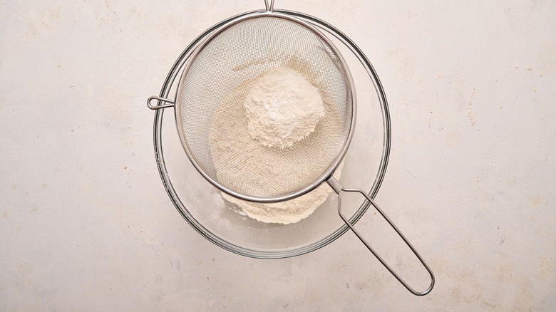 sifting flour into bowl