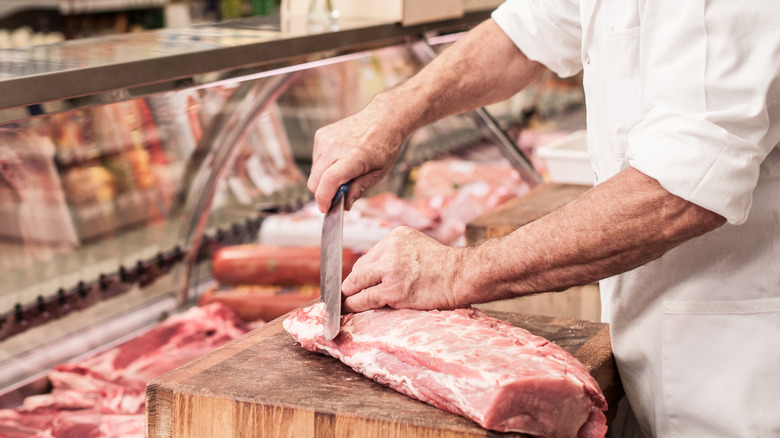 Butcher cutting meat