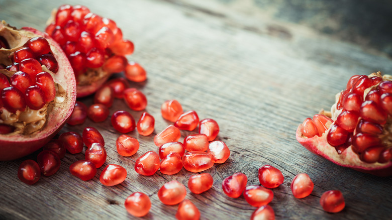 Pomegranate seeds on wood table