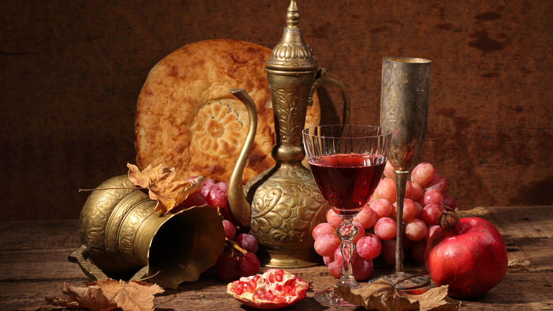 Wine, jug, bread, grapes, pomegranate