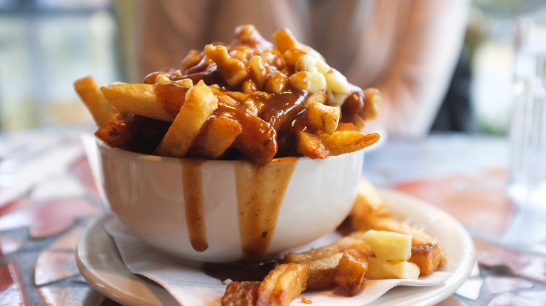 Messy bowl of poutine fries