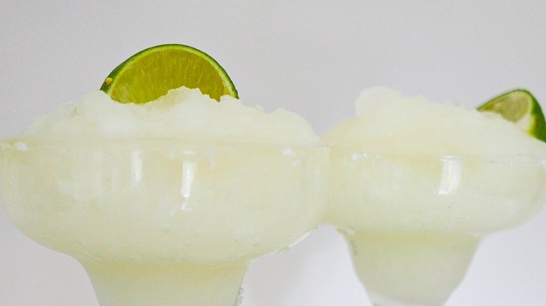 frozen margaritas with lime garnish