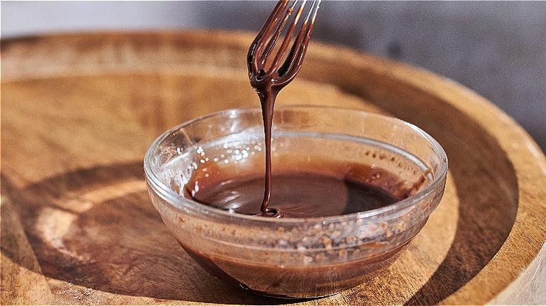 whisking chocolate sauce in bowl