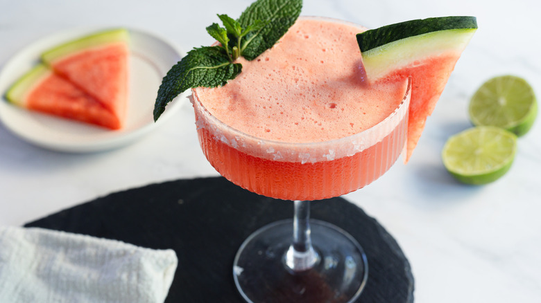 Watermelon margarita glass with garnishes and napkin