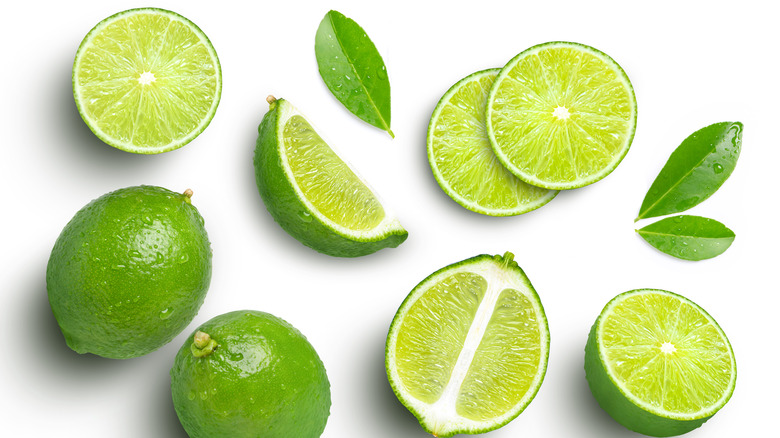 Sliced limes on white background