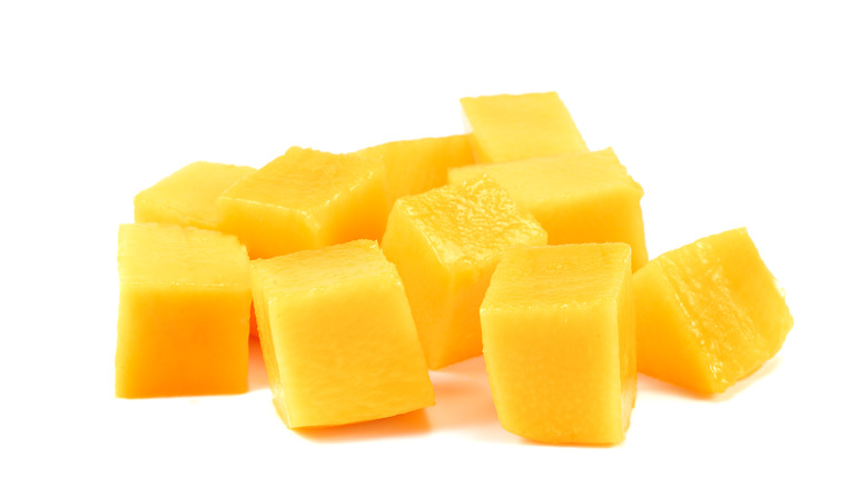 Cubed mango on white background