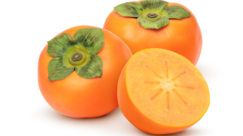 Persimmons on white background