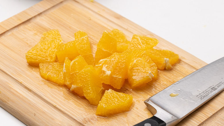 sliced orange on chopping board