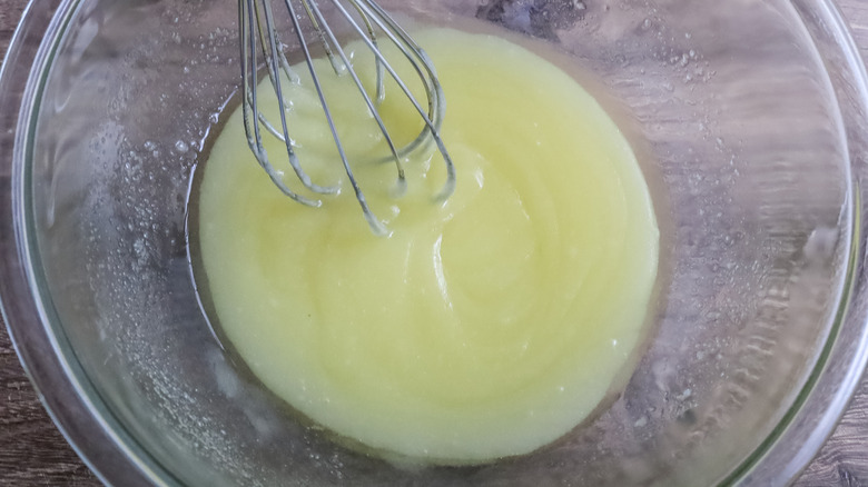 whisking melted butter and sugar