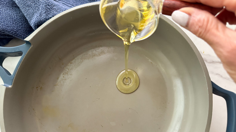 adding oil to pan