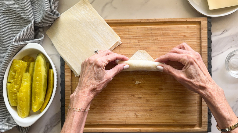 hands rolling eggroll