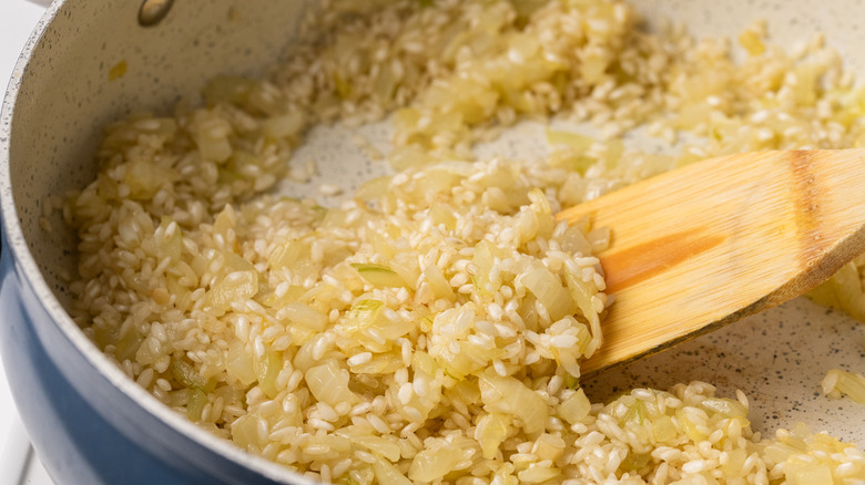 Toasting risotto rice in a pan