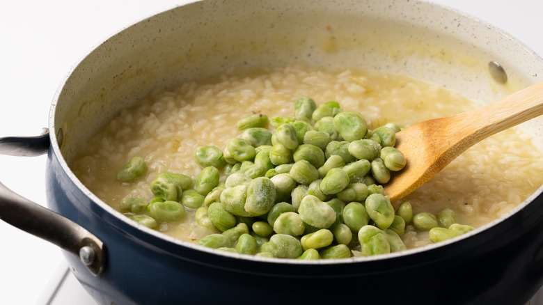 Adding broad beans to risotto