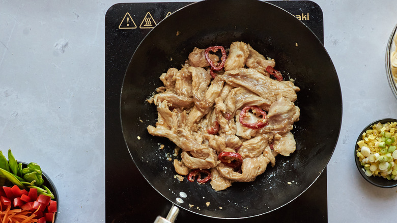 chicken cooking in a wok