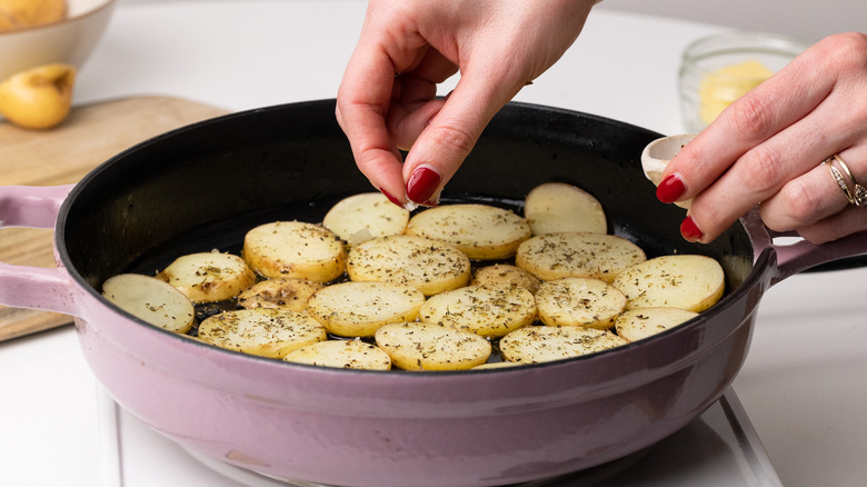 potato slices in frying pan