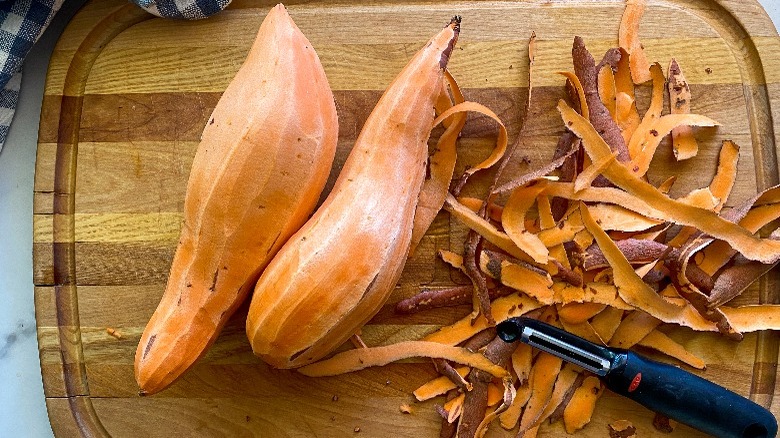 peeled sweet potatoes on cutting board