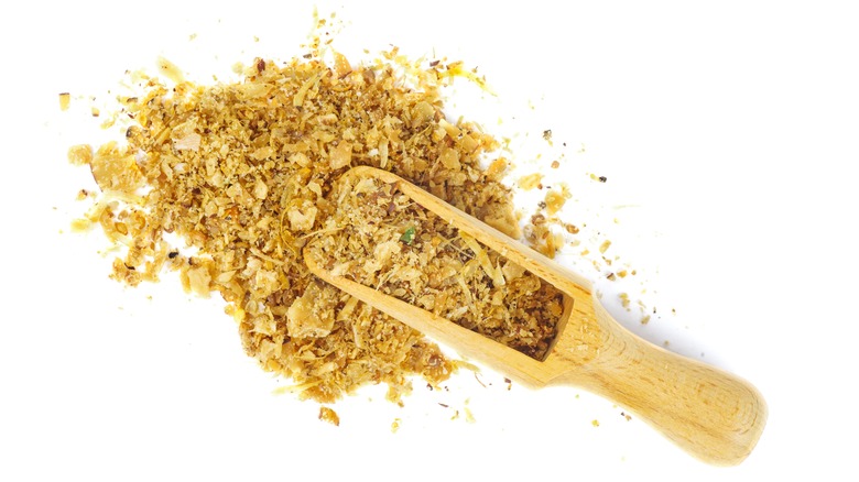 pile of Asafoetida with scoop on white background