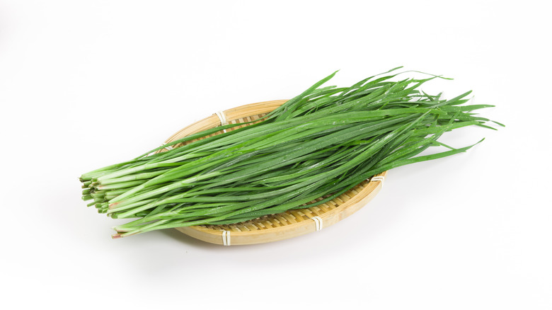 bunch of chives on bamboo dish