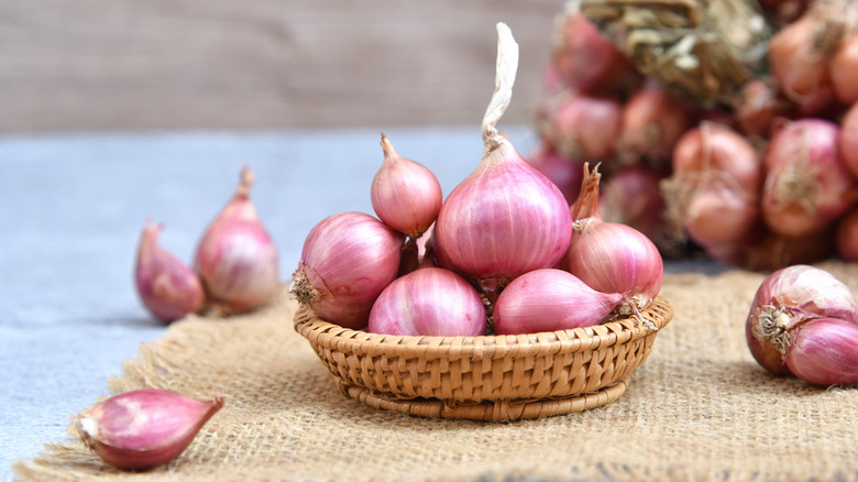 shallots in basket on burlap placemat