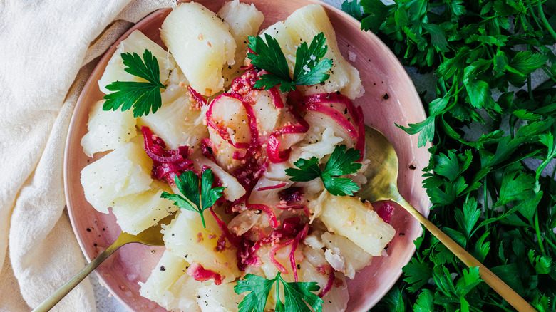 Boiled yuca with spoons and cilantro