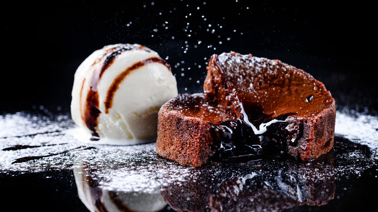 An open lava cake with a scoop of ice cream