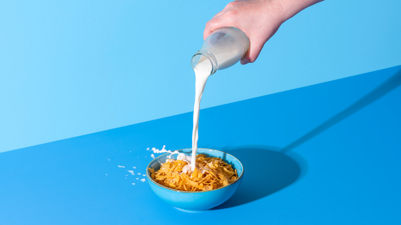 Milk pouring into cereal bowl