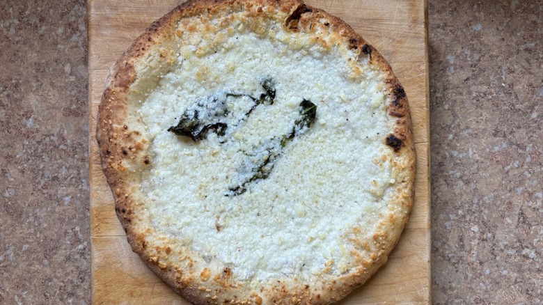 White pizza with green leaves