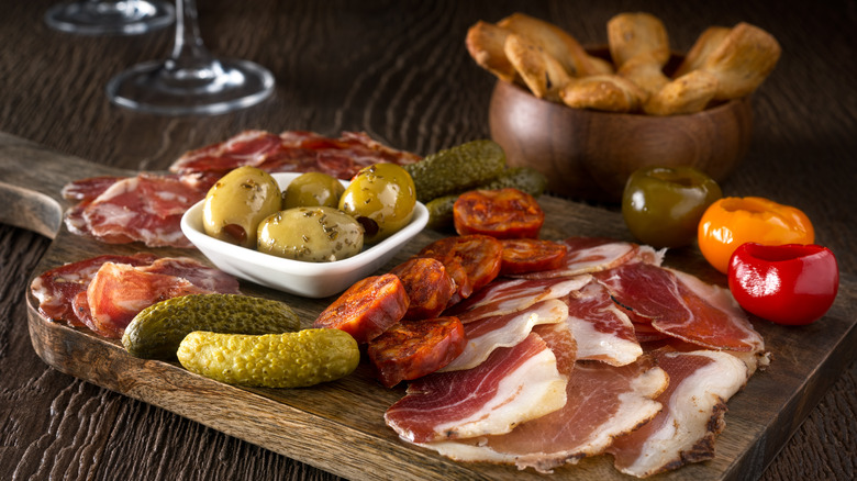 Charcuterie board with meats and pickles 