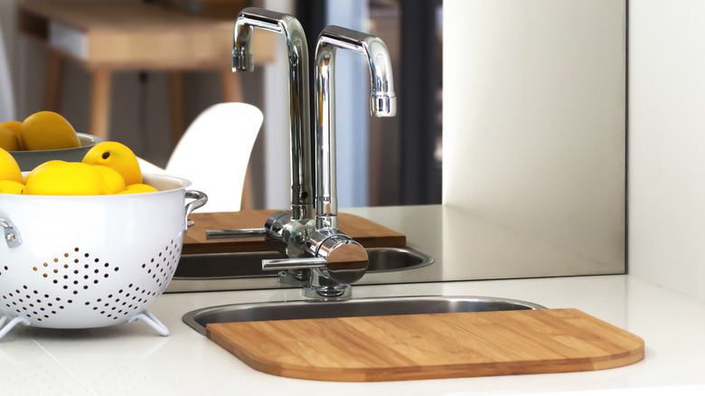 Cutting board placed over sink